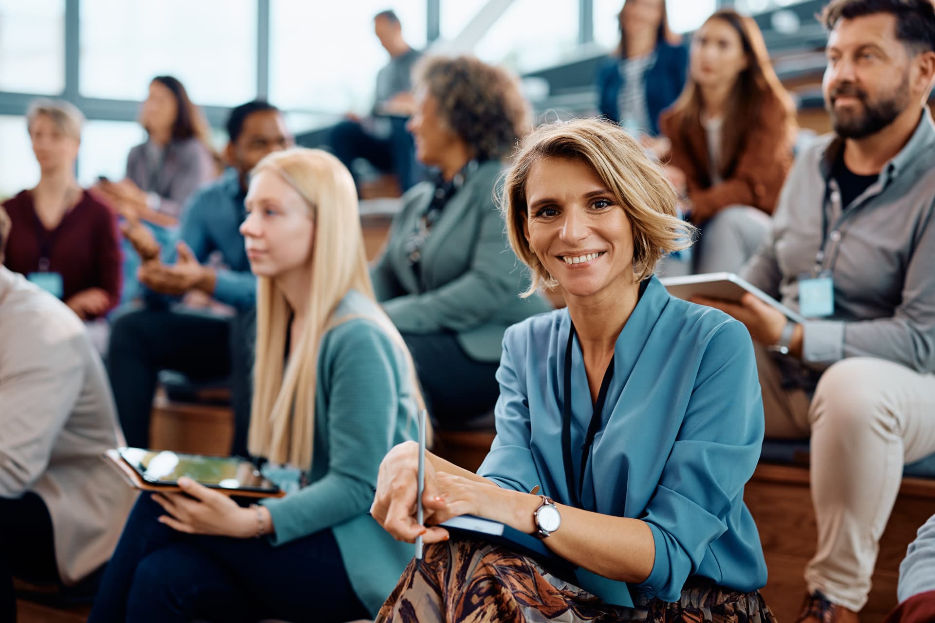 Attendees seated in a bright lecture hall at a leadership summit
