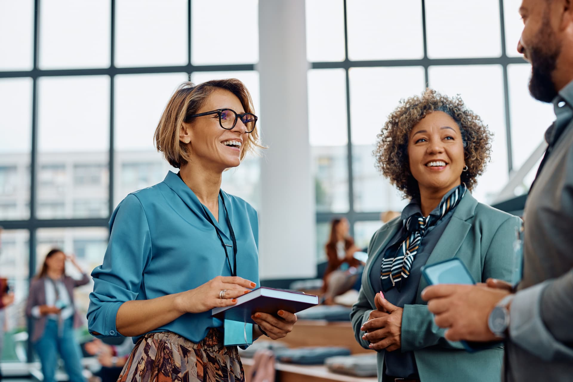 Attendees in conversation during a break at a leadership event